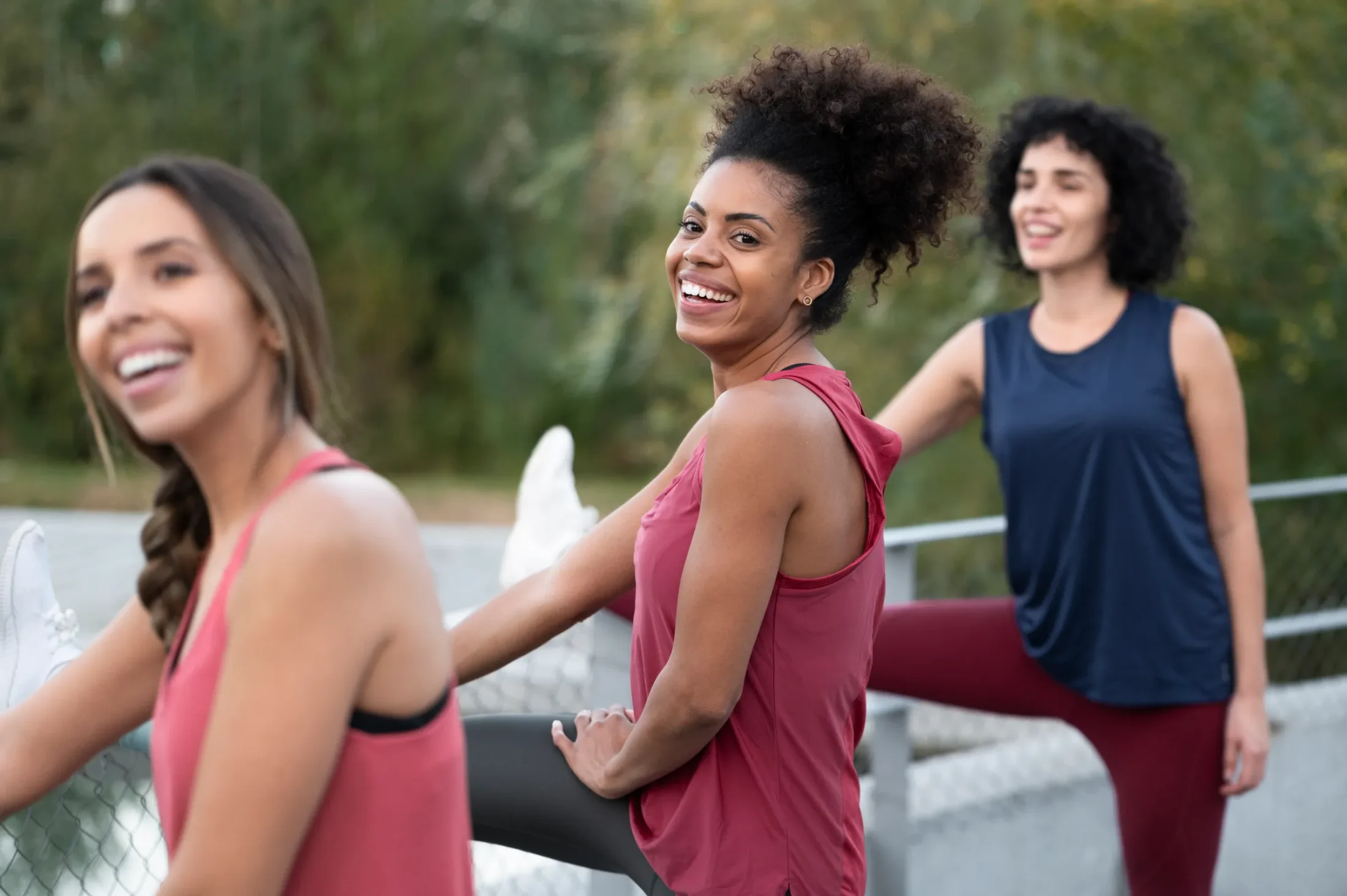 Smiling woman stretching during workout session