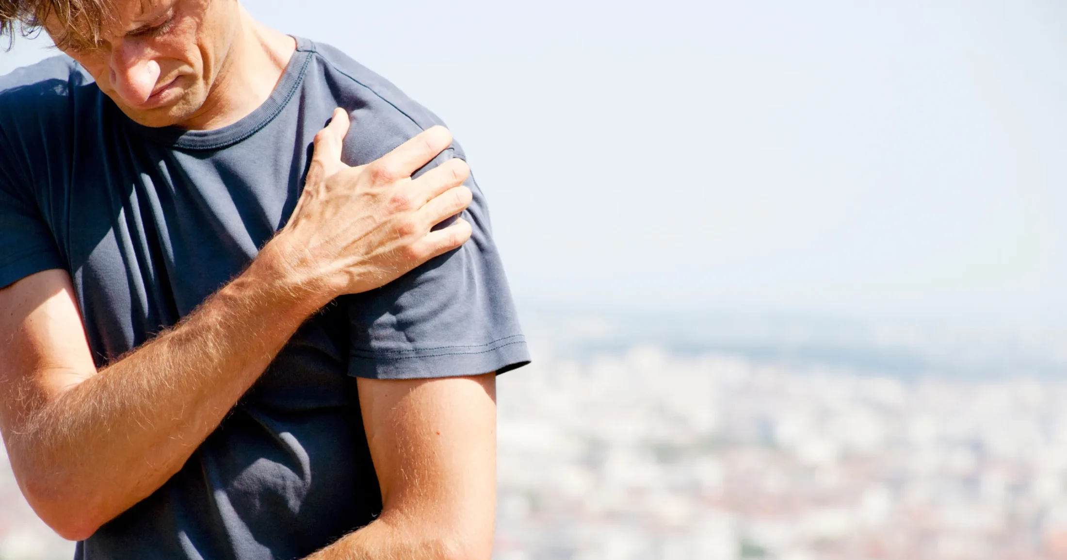 Man holding his shoulder