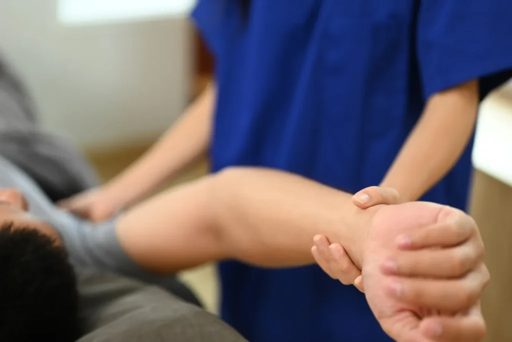 Doctor managing a patients arm mobility