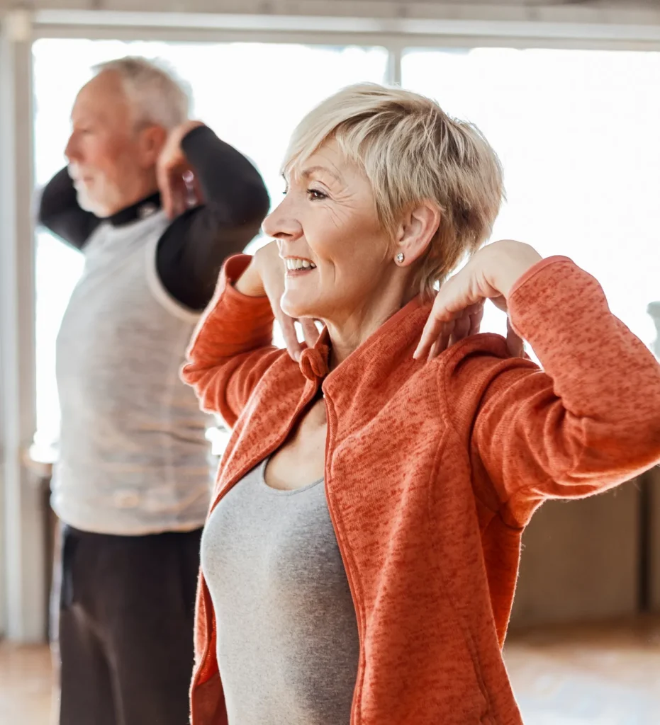 Man and woman touching their shoulders
