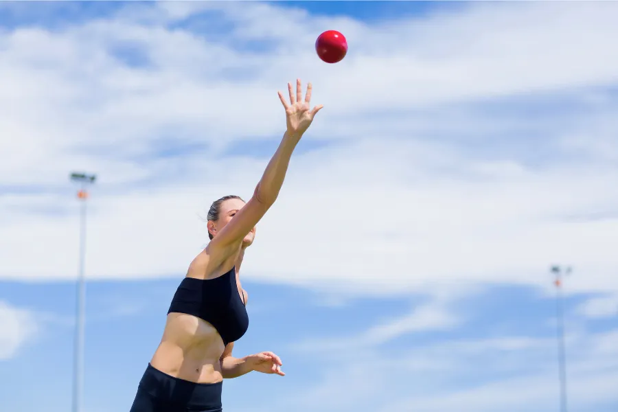 Woman throwing ball up in the air